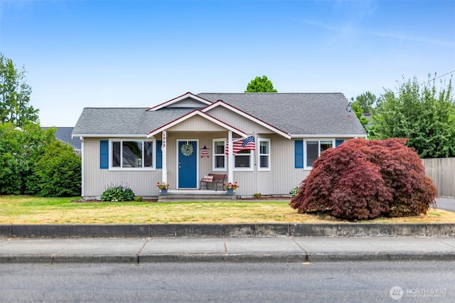 1702 7th Ave SW, Puyallup, WA 98371 - view of front facade with roof with shingles, a front yard, and a porch