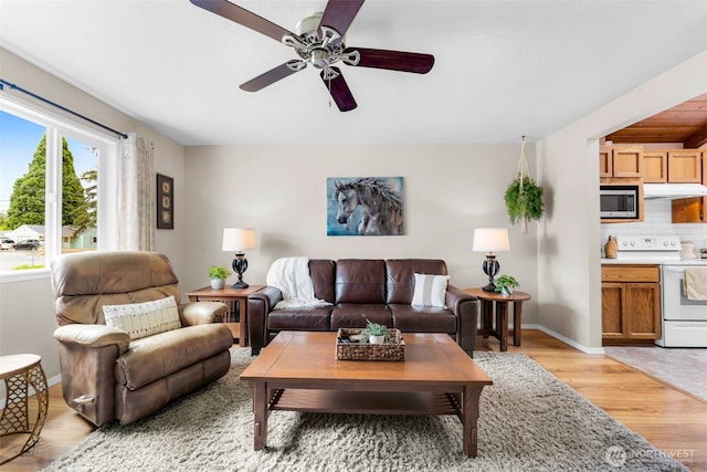 1702 7th Ave SW, Puyallup, WA 98371 - living room with light wood finished floors and a ceiling fan