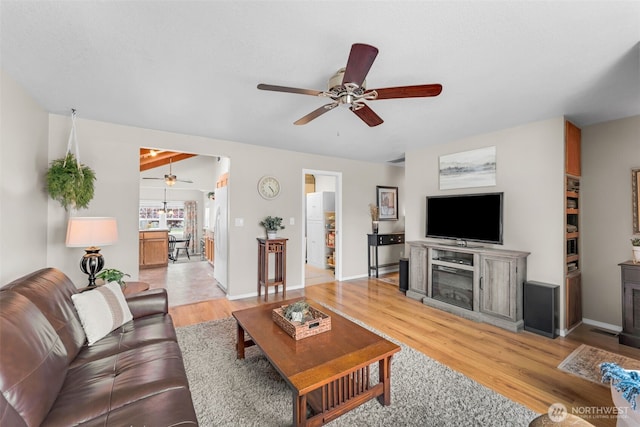 1702 7th Ave SW, Puyallup, WA 98371 - living room featuring ceiling fan, light wood-style flooring, and a glass covered fireplace