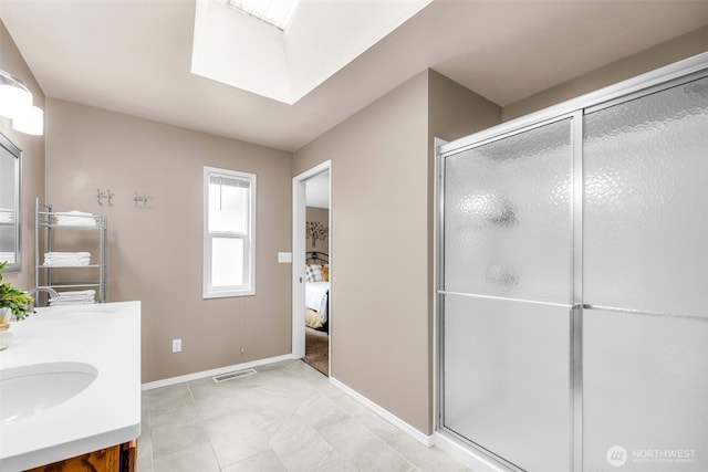 1702 7th Ave SW, Puyallup, WA 98371 - ensuite bathroom featuring double vanity, a shower stall, and a skylight