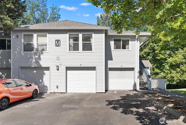 33020 10th Ave SW Unit M302, Federal Way, WA 98023 - view of front of home with a garage, asphalt driveway, and a shingled roof