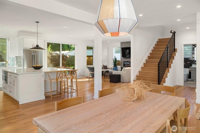 10419 41st Ave SW Unit A & B, Seattle, WA 98146 - dining space featuring plenty of natural light, light wood-type flooring, recessed lighting, and stairs