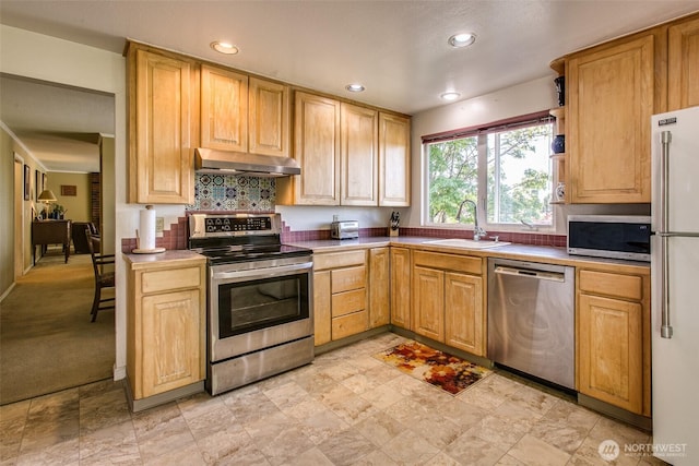 2120 Niagara Dr, Bellingham, WA 98229 - kitchen with appliances with stainless steel finishes, under cabinet range hood, recessed lighting, tasteful backsplash, and light brown cabinetry