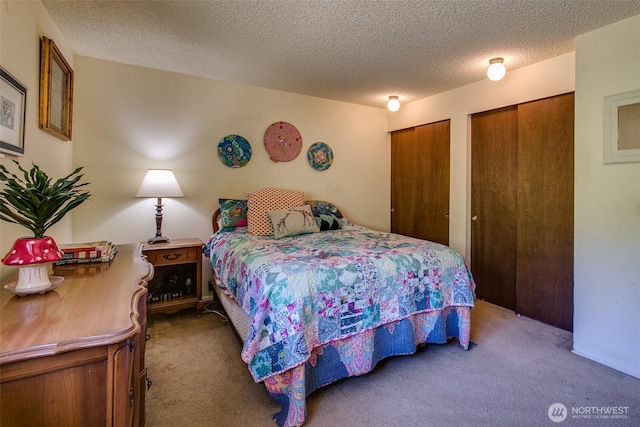 2120 Niagara Dr, Bellingham, WA 98229 - carpeted bedroom featuring multiple closets and a textured ceiling
