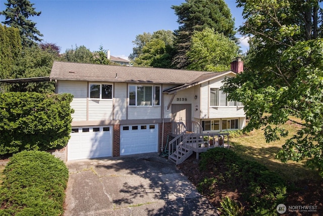 2120 Niagara Dr, Bellingham, WA 98229 - split foyer home with driveway, a chimney, and a garage