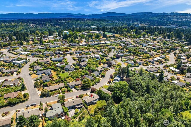 1823 121st Ave SE, Bellevue, WA 98005 - aerial view of residential area featuring a mountain backdrop and a heavily wooded area