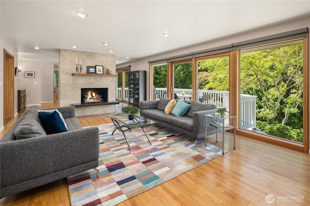 1823 121st Ave SE, Bellevue, WA 98005 - living area with wood finished floors, a large fireplace, and recessed lighting