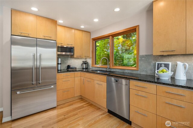 1823 121st Ave SE, Bellevue, WA 98005 - kitchen featuring appliances with stainless steel finishes, dark stone counters, light wood finished floors, decorative backsplash, and recessed lighting