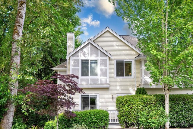 6707 SE Cougar Mountain Way Unit 2, Bellevue, WA 98006 - view of front of home featuring a chimney and roof with shingles