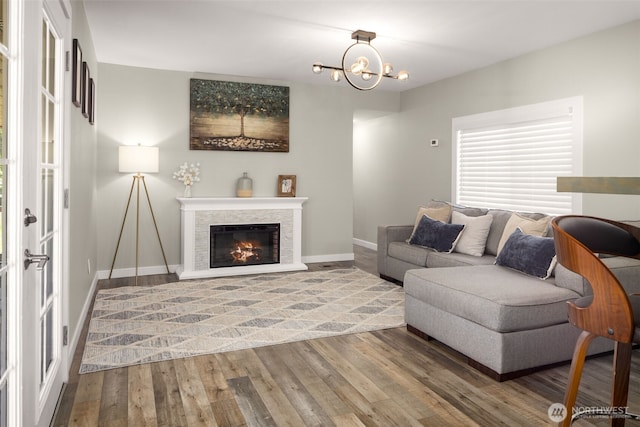 8730 206th St SE Unit 10, Snohomish, WA 98296 - living room with wood finished floors, a chandelier, and a glass covered fireplace