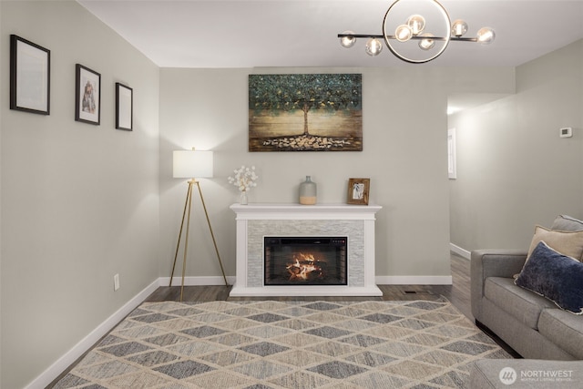 8730 206th St SE Unit 10, Snohomish, WA 98296 - living area featuring wood finished floors, a chandelier, and a glass covered fireplace