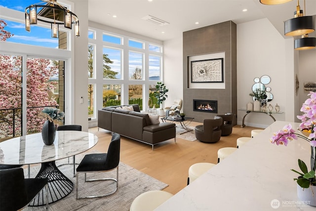 240 W Lake Sammamish Pkwy SE, Bellevue, WA 98008 - living room featuring a high ceiling, wood finished floors, recessed lighting, and a large fireplace