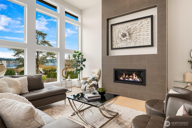 240 W Lake Sammamish Pkwy SE, Bellevue, WA 98008 - living room featuring a tiled fireplace, wood finished floors, and a high ceiling