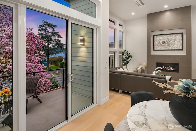 240 W Lake Sammamish Pkwy SE, Bellevue, WA 98008 - doorway to outside with light wood-type flooring, a fireplace, and recessed lighting