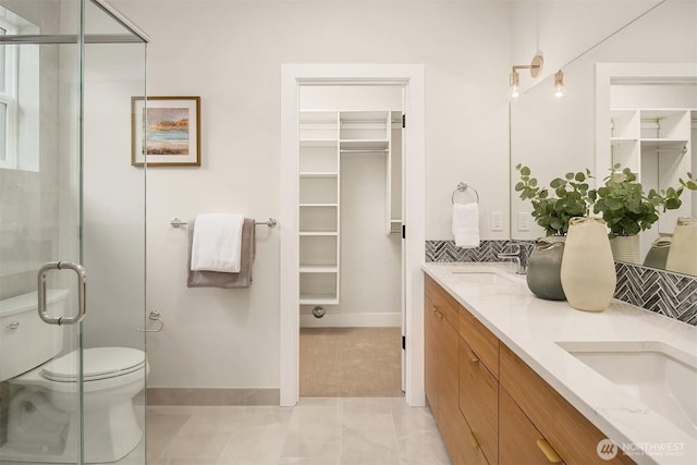 240 W Lake Sammamish Pkwy SE, Bellevue, WA 98008 - bathroom featuring a spacious closet, double vanity, a stall shower, and backsplash