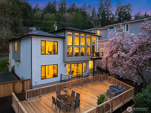 240 W Lake Sammamish Pkwy SE, Bellevue, WA 98008 - back of house at dusk with a deck and outdoor dining space