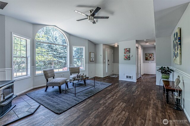 18920 217th Ave E, Orting, WA 98360 - sitting room with wood finished floors, lofted ceiling, ceiling fan, a wood stove, and a wainscoted wall