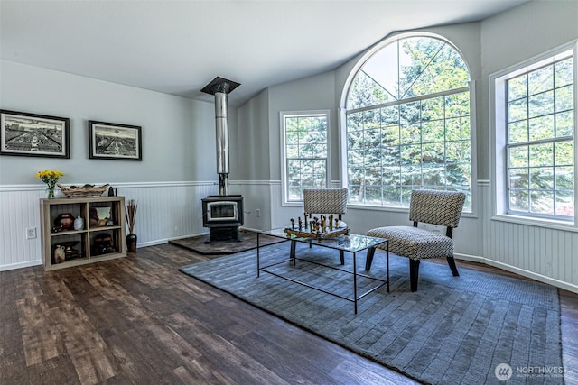 18920 217th Ave E, Orting, WA 98360 - living area with wood finished floors, plenty of natural light, a wood stove, wainscoting, and vaulted ceiling