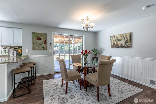 18920 217th Ave E, Orting, WA 98360 - dining area with a chandelier, wainscoting, and dark wood-type flooring