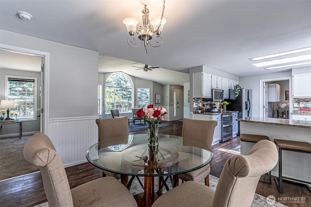 18920 217th Ave E, Orting, WA 98360 - dining room featuring dark wood finished floors, a chandelier, a wainscoted wall, and ceiling fan