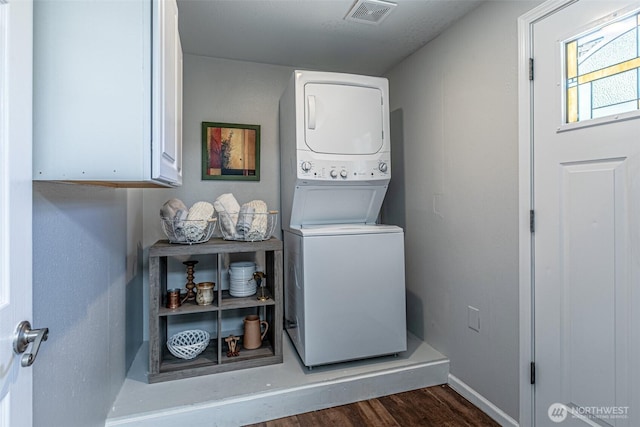 18920 217th Ave E, Orting, WA 98360 - laundry room with estacked washer and dryer, cabinet space, and dark wood-style floors