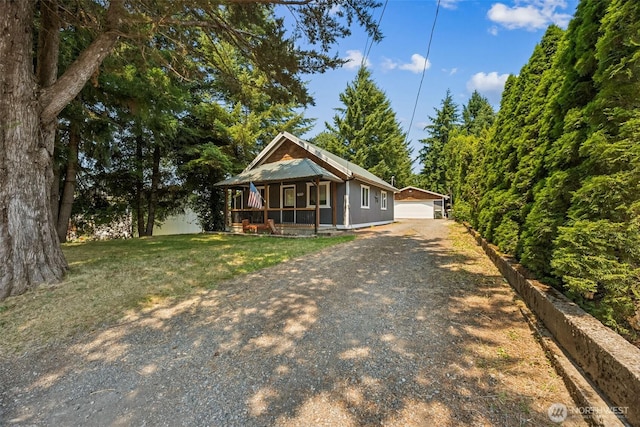 610 Westlake Ave, Morton, WA 98356 - view of front of house with a porch, an outdoor structure, and a front yard