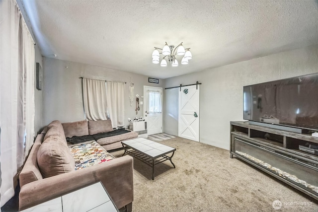 610 Westlake Ave, Morton, WA 98356 - living room with a barn door, a chandelier, a textured ceiling, and carpet