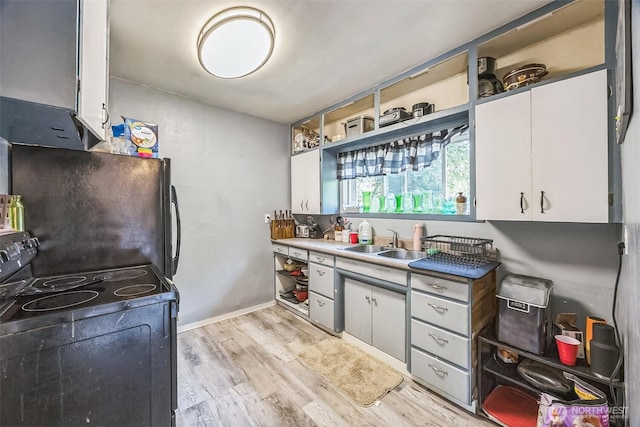 610 Westlake Ave, Morton, WA 98356 - kitchen featuring black range with electric stovetop, light wood finished floors, refrigerator, and white cabinets
