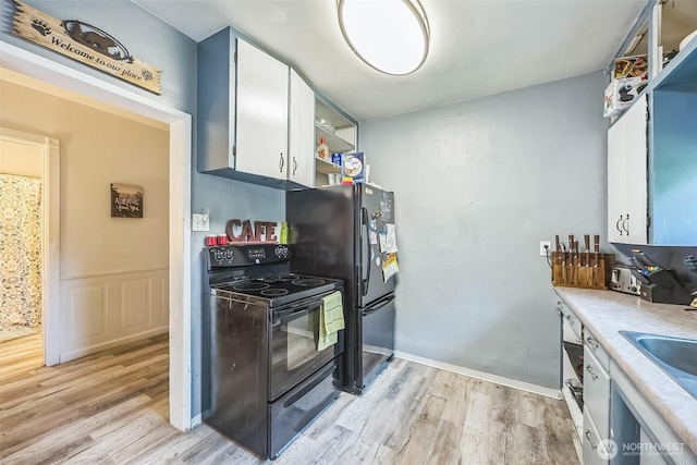 610 Westlake Ave, Morton, WA 98356 - kitchen featuring black appliances, light wood finished floors, white cabinets, light countertops, and open shelves