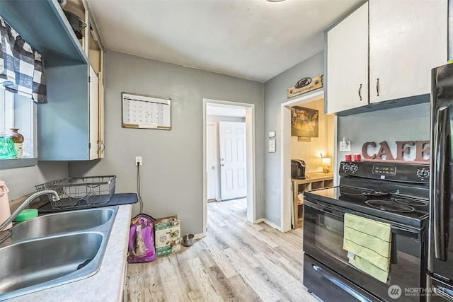 610 Westlake Ave, Morton, WA 98356 - kitchen with black / electric stove, light wood finished floors, white cabinetry, and light countertops