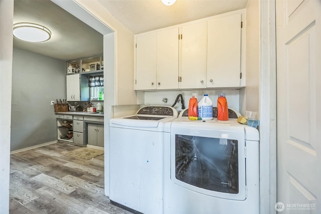 610 Westlake Ave, Morton, WA 98356 - laundry area featuring washer and dryer, wood finished floors, and cabinet space