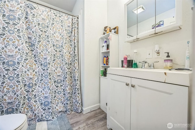 610 Westlake Ave, Morton, WA 98356 - bathroom featuring wood finished floors, vanity, and a shower with curtain