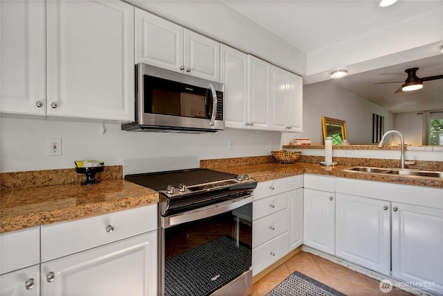 2300 Jefferson Ave NE Unit F-126, Renton, WA 98056 - kitchen featuring appliances with stainless steel finishes, light tile patterned floors, white cabinetry, and ceiling fan