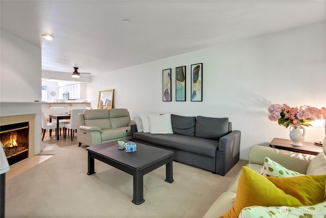 2300 Jefferson Ave NE Unit F-126, Renton, WA 98056 - living area featuring ceiling fan, light colored carpet, and a tiled fireplace