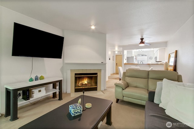 2300 Jefferson Ave NE Unit F-126, Renton, WA 98056 - carpeted living area featuring a ceiling fan and a tiled fireplace