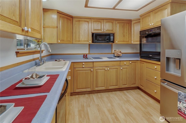 7127 Fair Oaks Loop SE, Olympia, WA 98513 - kitchen featuring black appliances, light wood-style flooring, and light countertops