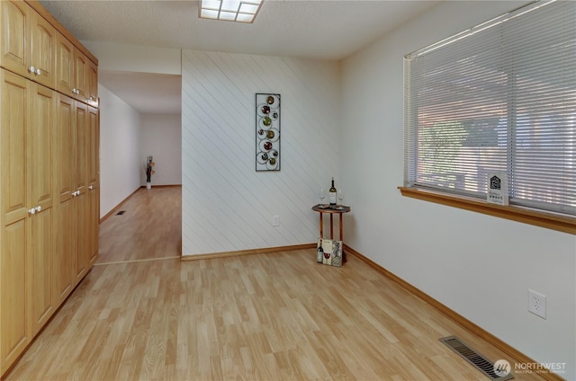 7127 Fair Oaks Loop SE, Olympia, WA 98513 - spare room with light wood-style flooring and wood walls