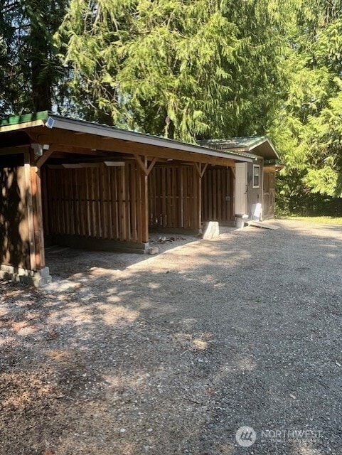 20011 Tveit Rd, Arlington, WA 98223 - garage featuring driveway and a carport