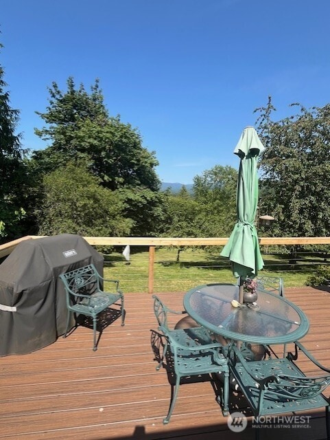 20011 Tveit Rd, Arlington, WA 98223 - wooden deck featuring grilling area and outdoor dining area