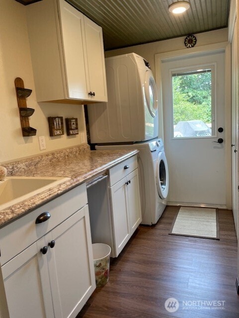 20011 Tveit Rd, Arlington, WA 98223 - laundry area with stacked washer / dryer, wood ceiling, and dark wood-type flooring