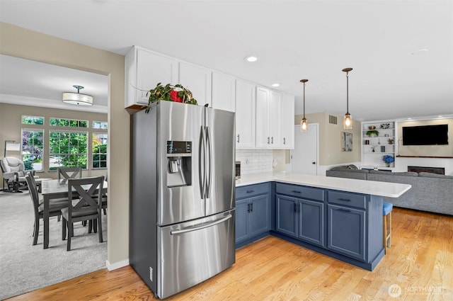 5115 150th St SE, Everett, WA 98208 - kitchen with stainless steel fridge with ice dispenser, open floor plan, a peninsula, white cabinets, and recessed lighting