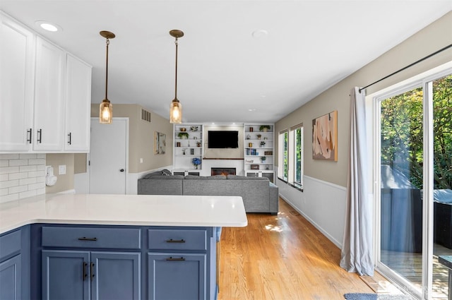 5115 150th St SE, Everett, WA 98208 - kitchen featuring blue cabinets, a peninsula, and plenty of natural light