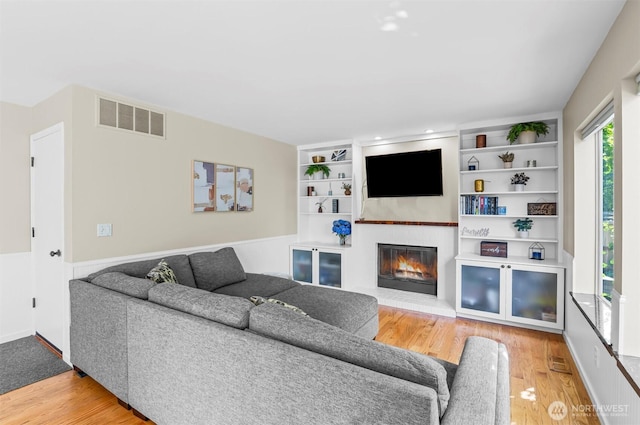 5115 150th St SE, Everett, WA 98208 - living room featuring a glass covered fireplace, wood finished floors, and built in shelves