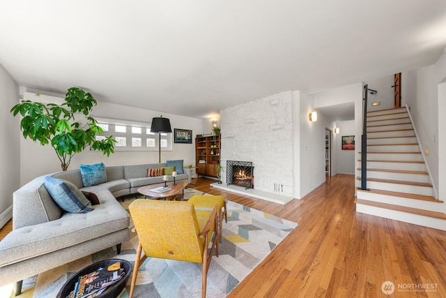 3516 NE 43rd St, Seattle, WA 98105 - living room featuring wood finished floors, a stone fireplace, and stairway