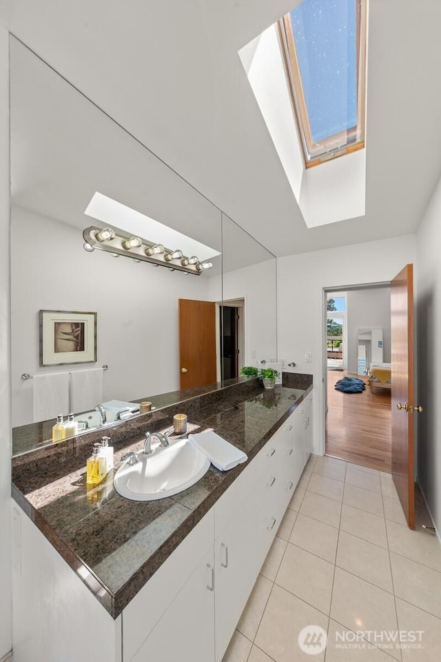 3516 NE 43rd St, Seattle, WA 98105 - bathroom with a skylight, tile patterned flooring, and vanity