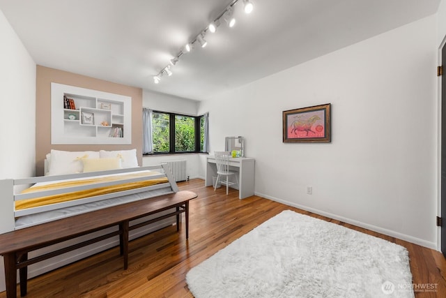 3516 NE 43rd St, Seattle, WA 98105 - bedroom with radiator heating unit, rail lighting, and wood finished floors