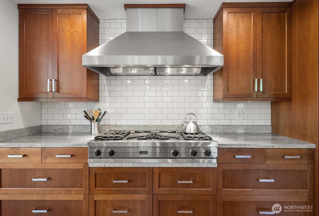 3516 NE 43rd St, Seattle, WA 98105 - kitchen featuring wall chimney range hood, stainless steel gas stovetop, brown cabinetry, and backsplash