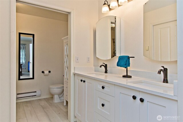15325 SE 155th Pl Unit K1, Renton, WA 98058 - full bath featuring a baseboard radiator, double vanity, and wood finished floors