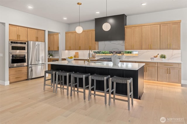 16429 Snohomish Ave SE, Clearview, WA 98296 - kitchen with stainless steel appliances, range hood, light brown cabinetry, a kitchen breakfast bar, and recessed lighting
