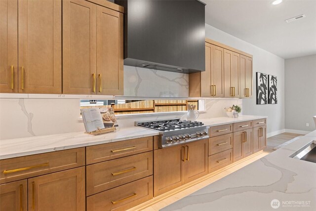 16429 Snohomish Ave SE, Clearview, WA 98296 - kitchen featuring stainless steel gas stovetop, wall chimney exhaust hood, backsplash, light stone countertops, and recessed lighting